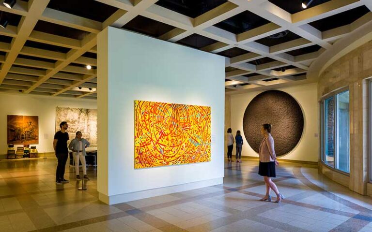 modern art exhibit layout with yellow abstract painting and viewers at cummer museum of art and gardens jacksonville