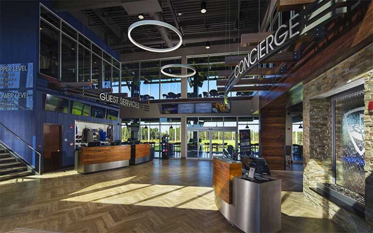 modern lobby area with atria concierge desk at topgolf jacksonville