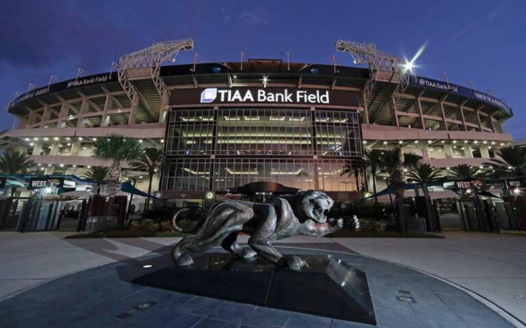 night exterior front of stadium with jaguar statue at tiaa bank field jacksonville