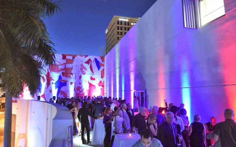 night exterior of balcony area with colorful lighting and crowd for event at nsu art museum ft lauderdale
