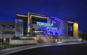 night exterior of modern building with street front at topgolf jacksonville