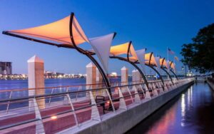 night walkway along river with sailboat-like canopies at southbank riverwalk jacksonville