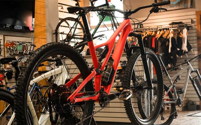 orange bicycle on rack with bike accessories in store at shoppes of avondale jacksonville