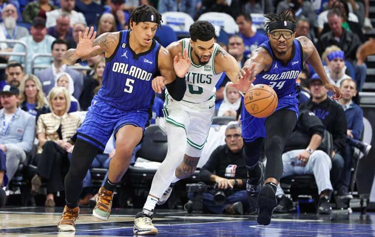 orlando magic players reaching for the basketball at amway center