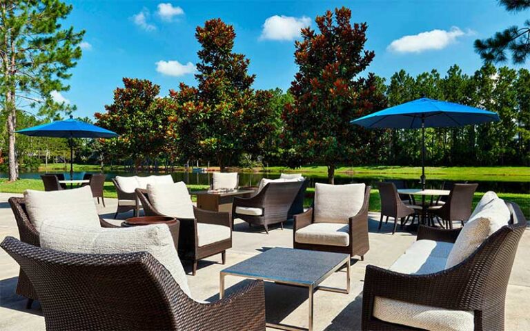 outdoor patio area with furniture umbrellas and trees at sheraton hotel jacksonville