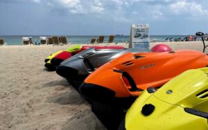 row of seabobs on beach with sign at beach ventures ft lauderdale