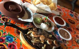 shrimp fajitas in a black skillet at casita tejas homestead