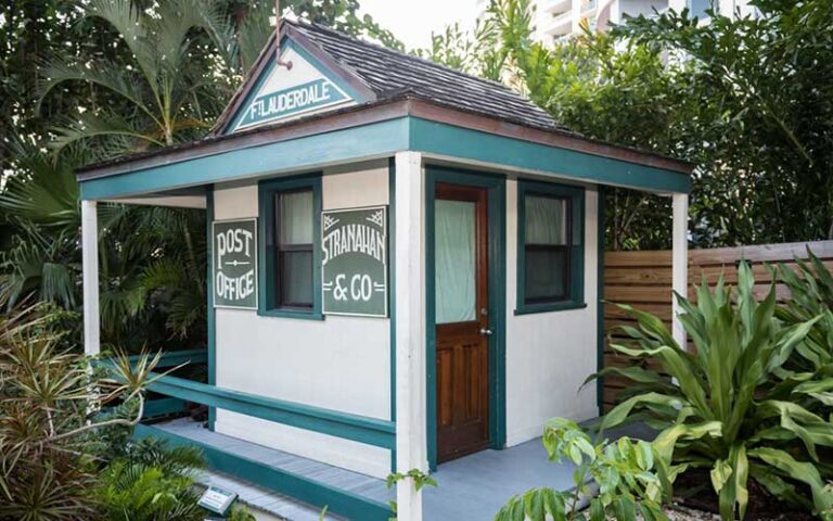 small office building with vintage signs post office in outdoor garden area at historic stranahan house museum ft lauderdale