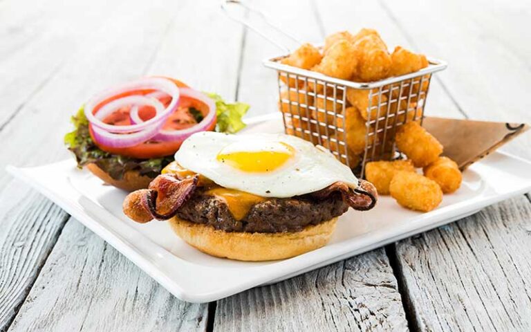 specialty burger entree with egg and bacon and tots at topgolf jacksonville