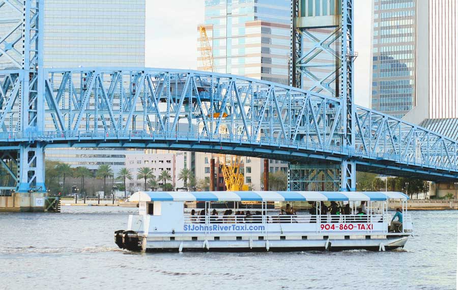 st johns river taxi boat on water with bridge and city skyline for jacksonville fun facts post