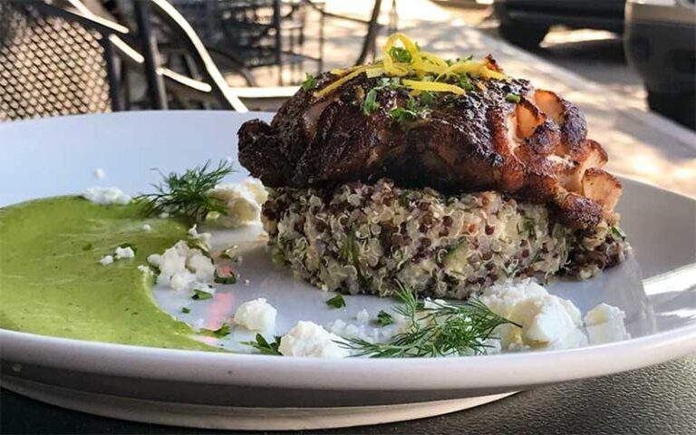 steak entree with couscous plated with pesto at biscottis jacksonville
