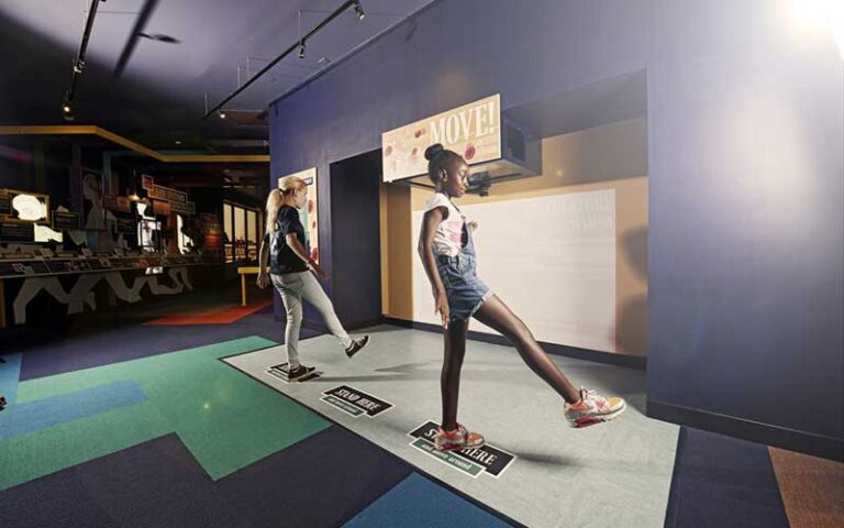 two girls interacting with fitness exhibit at mosh museum of science history jacksonville