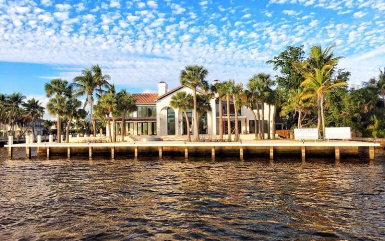 view from river of historic home with palms on bank at carrie b cruises ft lauderdale