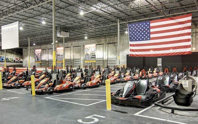 warehouse track with rows of karts and american flag at autobahn indoor speedway events jacksonville