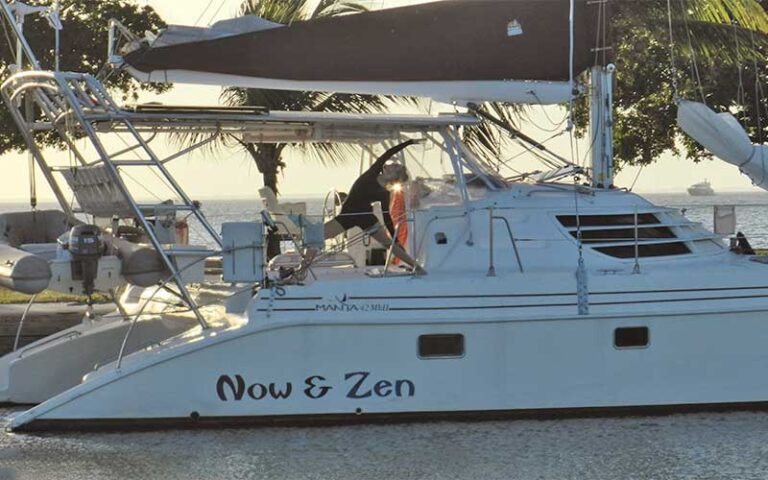 woman doing yoga on deck of boat at dock at now and zen sailboat charters jacksonville