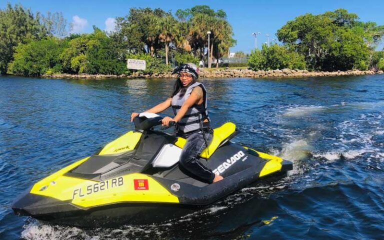 woman on jet ski with jetty inlet behind at beach ventures ft lauderdale