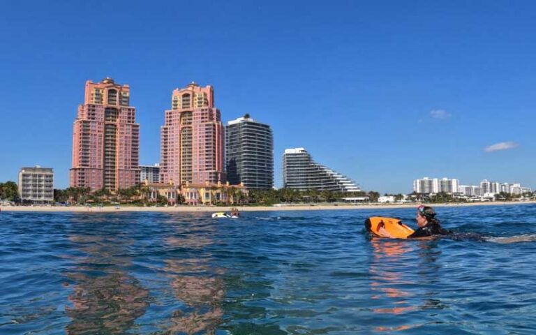 woman riding seabob with condo towers at beach ventures ft lauderdale