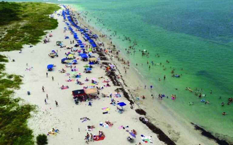 aerial of busy crowded beach at bill baggs cape florida state park miami