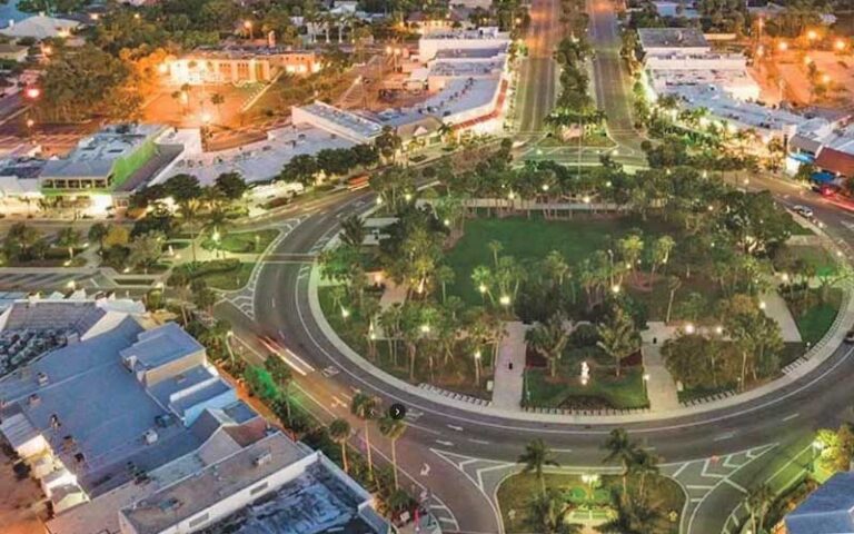 aerial view of circular park at night with lights stores and cars on round street at st armands circle sarasota