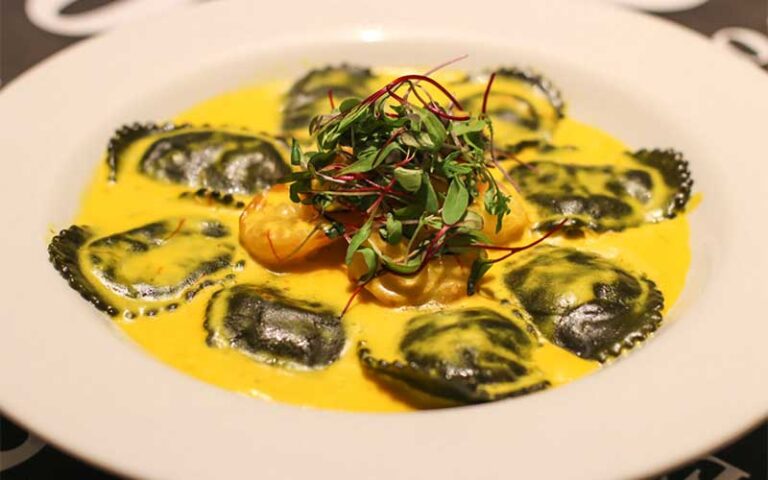 black ravioli with yellow sauce entree at novecento miami