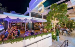 busy outdoor patio at night with diners at michaels genuine miami
