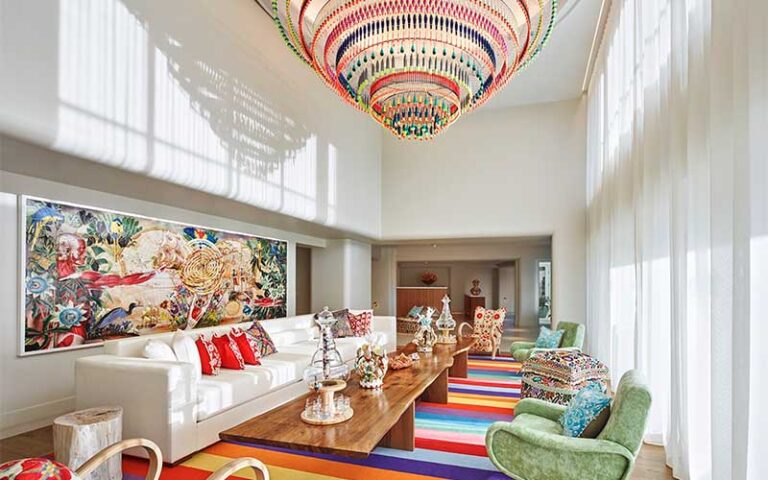 colorful chandelier white walls sofas and chairs at faena hotel miami beach