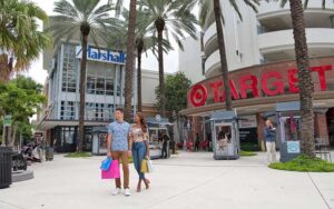 couple shopping outside target store with trees at shops at midtown miami