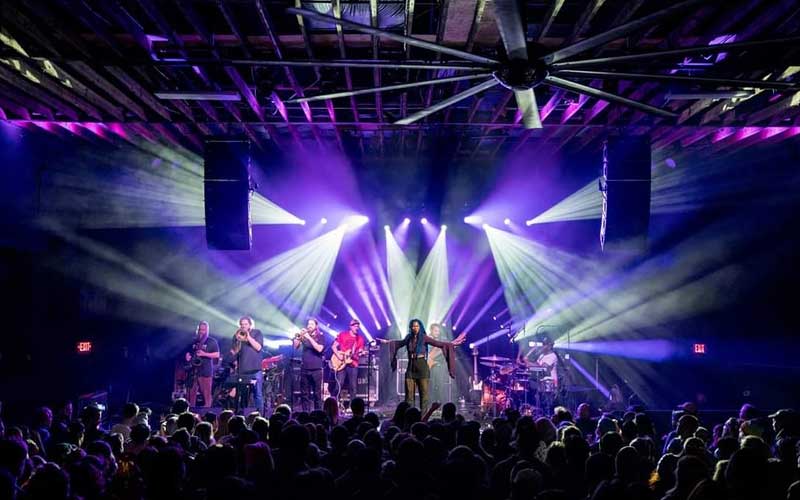 crowded music concert with blue and purple lighting and female singer with band on stage at 1904 music hall jacksonville
