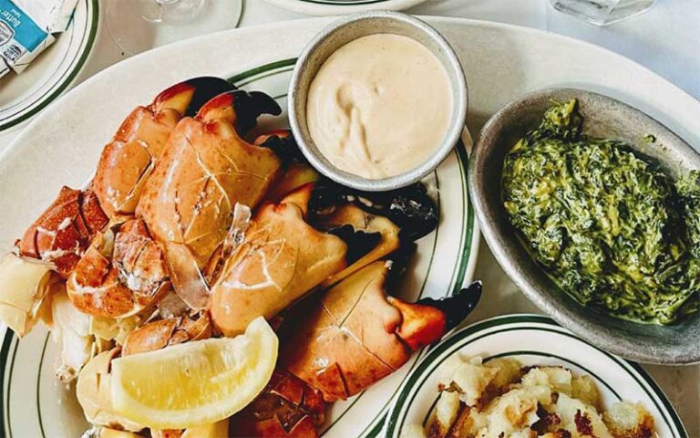 entrees with stone crab claws sauce and creamed spinach at joes stone crab miami