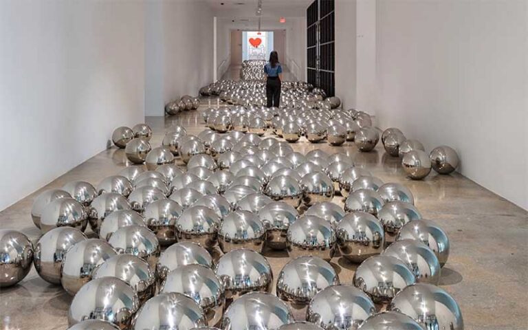 exhibit hall with hundreds of mirrored orbs at rubell museum miami