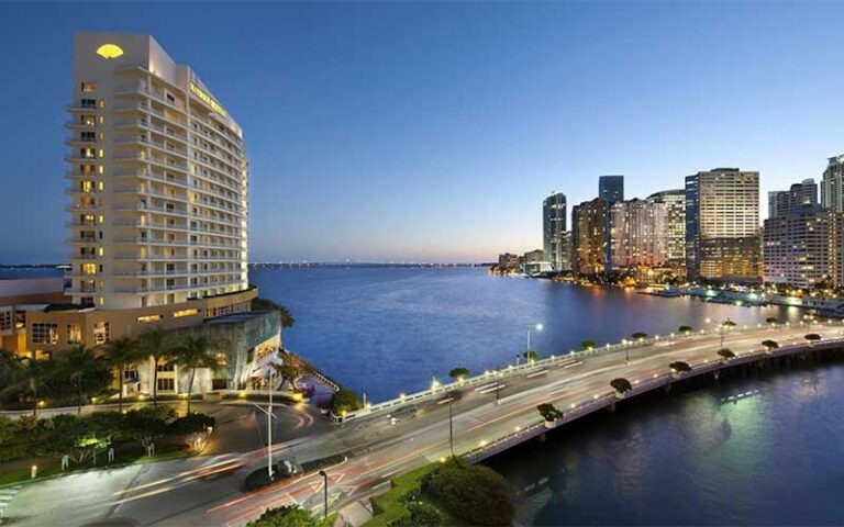 exterior aerial of hotel on left with bay bridge and high rises on right at mandarin oriental miami
