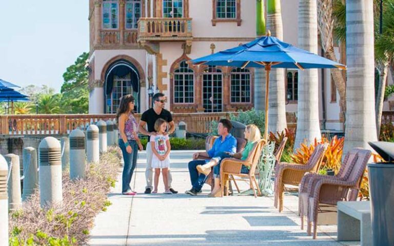 family sitting on patio at mansion with bay view at ca dzan museum sarasota