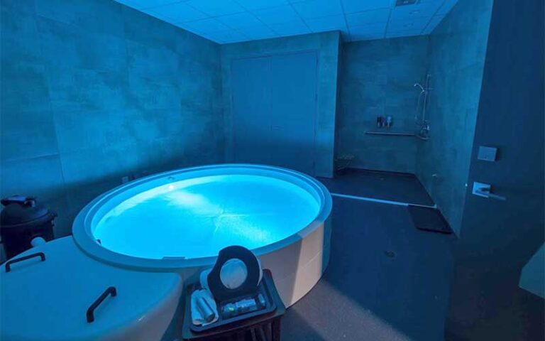 flotation tank in room with blue light at be still float studio jacksonville
