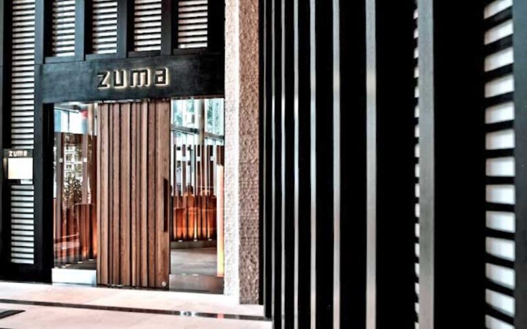 front entrance with sign above door and black vented design at zuma miami