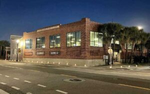 front exterior at night of bar with red brick at aardwolf brewing company jacksonville
