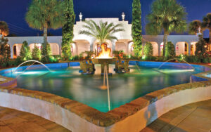 front exterior at night with fountain flames and trees at alhambra theatre jacksonville