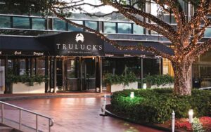 front exterior with awning sidewalk lighted tree and hedges at trulucks miami