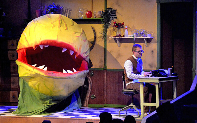 giant plant head on stage with character at desk at alhambra theatre jacksonville