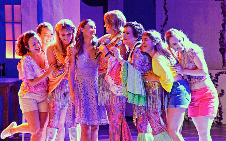 girls on stage with colorful lighting for mamma mia at alhambra theatre jacksonville