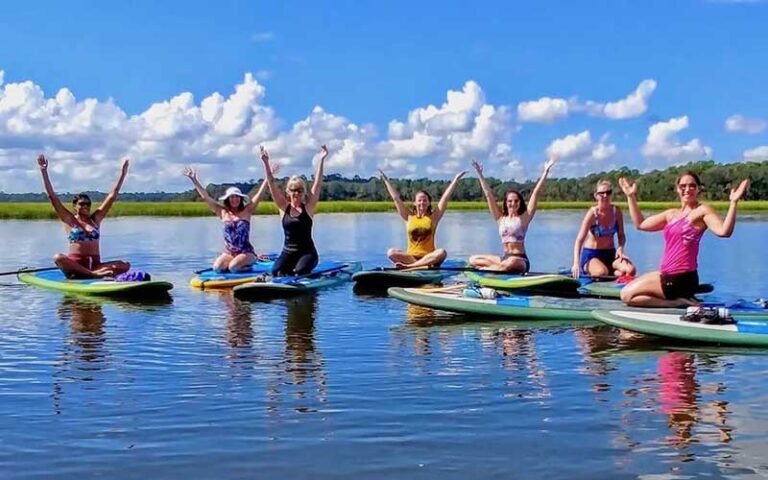 group of yoga girls on paddle boards at kayak amelia jacksonville