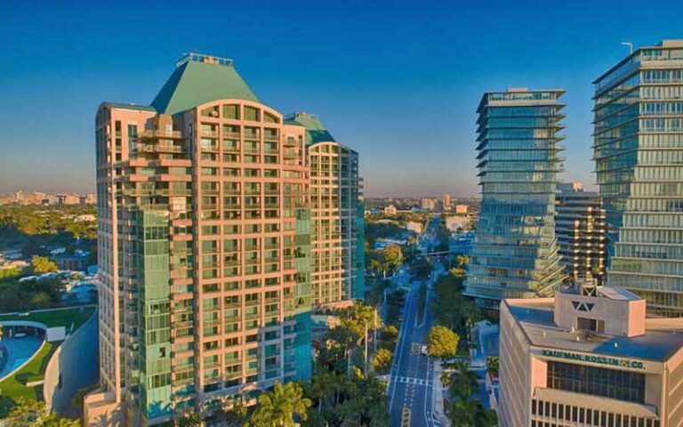 hotel high rise on left with warm sun lighting at ritz carlton miami