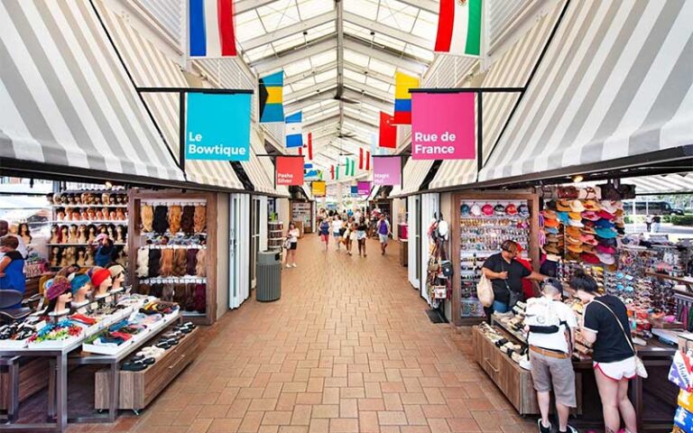 indoor market area with stores and booths on both sides and flags at bayside marketplace miami