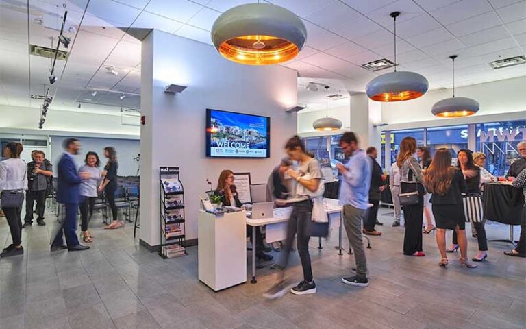 lobby interior with desks and crowd at miami center for architecture design