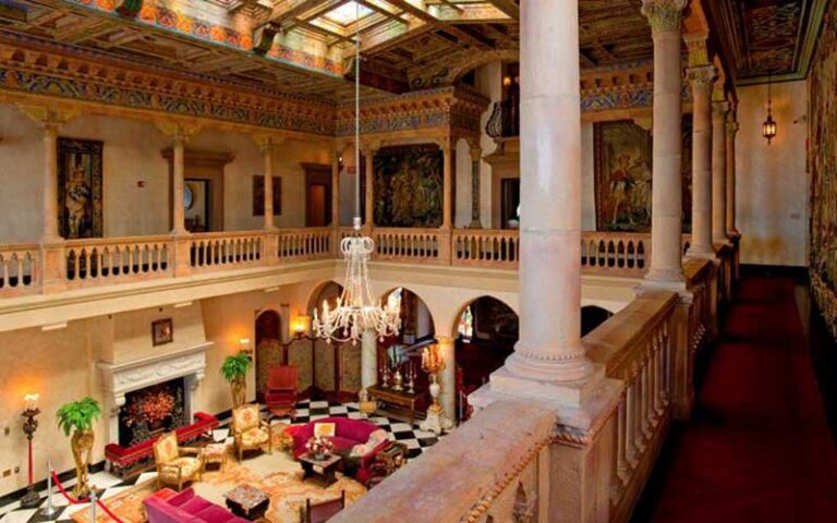 loft view of main room with atrium chandeliers and early century decor at ca dzan museum sarasota