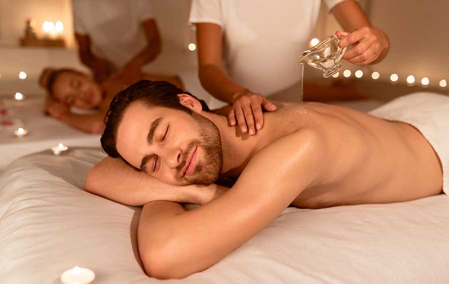 man and woman relaxing during couples massage with oil