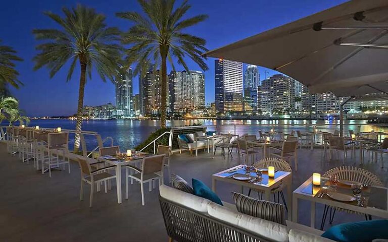 night dining deck at restaurant with candles at mandarin oriental miami