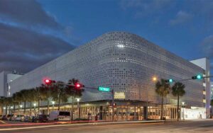 night time exterior of building on street corner with traffic lights at time out market miami