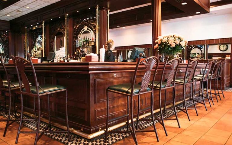 old fashioned wood bar area with bartender at joes stone crab miami