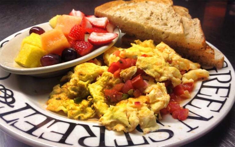 omelet with fruit and toast on branded plate at greenstreet cafe miami