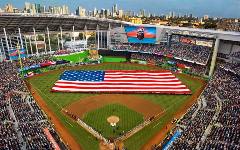 open stadium with game day crowd and american flag on field at loandepot park miami